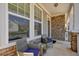 Comfortable front porch with stylish seating area, perfect for relaxing and enjoying the neighborhood at 526 Lost Creek Dr, Woodstock, GA 30188