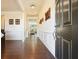 Inviting hallway with dark wood floors, white trim, and decorative wall art at 526 Lost Creek Dr, Woodstock, GA 30188