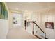 Spacious hallway with wood and white banister, plush carpeting, and open doorway with natural light at 526 Lost Creek Dr, Woodstock, GA 30188