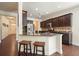 Open-concept kitchen featuring a granite island with seating at 526 Lost Creek Dr, Woodstock, GA 30188