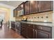 Well-equipped kitchen with dark wood cabinets and stainless steel appliances at 526 Lost Creek Dr, Woodstock, GA 30188