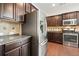 Close-up of a kitchen with stainless steel appliances and dark wood cabinetry at 526 Lost Creek Dr, Woodstock, GA 30188