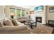 Cozy living room with a fireplace, hardwood floors, and large windows that bring in natural light at 526 Lost Creek Dr, Woodstock, GA 30188