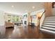Inviting living room featuring a fireplace, TV, hardwood flooring, and an adjacent staircase at 526 Lost Creek Dr, Woodstock, GA 30188
