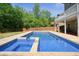 Backyard pool with adjacent hot tub and an ample patio is perfect for outdoor entertaining at 526 Lost Creek Dr, Woodstock, GA 30188