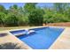 Backyard pool with adjacent hot tub and a lush green lawn is perfect for relaxation and fun at 526 Lost Creek Dr, Woodstock, GA 30188