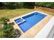 Backyard pool with adjacent hot tub and a lush green lawn is perfect for relaxation and fun at 526 Lost Creek Dr, Woodstock, GA 30188