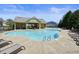 Sparkling community pool featuring a covered pavilion and ample lounge chairs for residents to enjoy the outdoors at 526 Lost Creek Dr, Woodstock, GA 30188