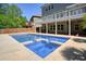 Backyard pool with adjacent hot tub and an ample patio is perfect for outdoor entertaining at 526 Lost Creek Dr, Woodstock, GA 30188