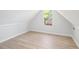An attic room with light gray walls, modern flooring, and a sunny window at 560 Austin Dr, Mcdonough, GA 30252