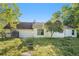Expansive backyard featuring lush grass, stepping stones, mature trees, and a white siding exterior at 560 Austin Dr, Mcdonough, GA 30252