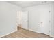 Bedroom featuring light walls, modern flooring, and white doors at 560 Austin Dr, Mcdonough, GA 30252