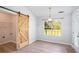 Dining area featuring sliding barn door and natural light at 560 Austin Dr, Mcdonough, GA 30252