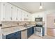 Bright kitchen features updated appliances, two-tone cabinets, and tile backsplash at 560 Austin Dr, Mcdonough, GA 30252