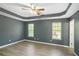 Spacious main bedroom with tray ceilings, laminate flooring, and lots of natural light at 560 Austin Dr, Mcdonough, GA 30252
