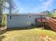 Home exterior featuring a backyard deck, green lawn, and easy access to outdoor entertaining space at 5790 Ivywood Dr, Lithonia, GA 30038