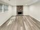 Basement room with a decorative rock fireplace, new flooring, and lots of light at 5790 Ivywood Dr, Lithonia, GA 30038