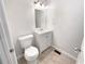 Bathroom featuring a toilet, sink, cabinet, mirror, and modern lighting fixtures at 5790 Ivywood Dr, Lithonia, GA 30038