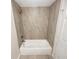 Modern bathroom showcasing a bathtub with shower and tiled walls, complete with fixtures at 5790 Ivywood Dr, Lithonia, GA 30038