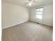 Neutral bedroom features plush carpeting, ceiling fan, and a large window for natural light at 5790 Ivywood Dr, Lithonia, GA 30038
