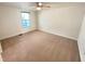 Spacious bedroom featuring neutral walls, carpet flooring, ceiling fan, and large window at 5790 Ivywood Dr, Lithonia, GA 30038