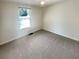 Bright bedroom with plush carpeting, modern ceiling fan, and a large window at 5790 Ivywood Dr, Lithonia, GA 30038