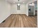 This brightly lit dining area features wood-look floors, a stainless fridge and a white door with window at 5790 Ivywood Dr, Lithonia, GA 30038