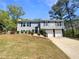 Charming two-story home with well-maintained landscaping, a spacious yard, and an attached garage at 5790 Ivywood Dr, Lithonia, GA 30038