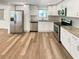 Bright kitchen featuring stainless steel appliances, granite countertops, and white cabinetry at 5790 Ivywood Dr, Lithonia, GA 30038
