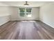 The space features light-colored walls, modern ceiling fan, and windows looking out onto the yard at 5790 Ivywood Dr, Lithonia, GA 30038