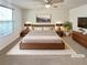 Comfortable bedroom with a ceiling fan, plush rug, and coordinated furniture set for relaxation at 5790 Ivywood Dr, Lithonia, GA 30038