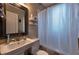 Cozy bathroom featuring a pedestal sink, mirrored vanity, and bathtub with a shower curtain at 741 Frederica Ne St # 8, Atlanta, GA 30306
