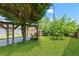 Expansive backyard featuring a covered area, lush lawn, and privacy fence at 873 United Se Ave, Atlanta, GA 30312
