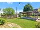 Lush backyard showcasing a pergola, string lights, green grass, mature trees, and privacy fencing at 873 United Se Ave, Atlanta, GA 30312