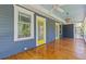 Long and inviting front porch featuring painted beadboard ceiling, three ceiling fans, glossy wood flooring, and decorative windows at 873 United Se Ave, Atlanta, GA 30312