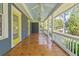 Spacious covered front porch featuring a beadboard ceiling, stylish light fixtures, and painted wood flooring at 873 United Se Ave, Atlanta, GA 30312
