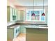 Light-filled kitchen boasts modern cabinets, granite countertops, bay window, and unique pendant lighting at 873 United Se Ave, Atlanta, GA 30312