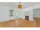 Bright living room with hardwood floors, fireplace, and a modern light fixture at 873 United Se Ave, Atlanta, GA 30312