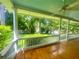 Inviting front porch with wooden floors, white railings, and view of a lush, green yard at 873 United Se Ave, Atlanta, GA 30312