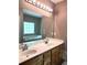Bright bathroom with a double sink vanity, a soaking tub and a large mirror above the sinks at 225 Austin Oaks Se Dr, Ellenwood, GA 30294