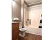 Bathroom featuring a vanity, toilet and tub with shower, wood laminate flooring and neutral colored walls at 225 Austin Oaks Se Dr, Ellenwood, GA 30294