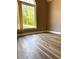 Bedroom featuring a tall arched window offering natural light, with wood laminate flooring at 225 Austin Oaks Se Dr, Ellenwood, GA 30294