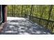 Large gray stained wooden deck for outdoor enjoyment near the tree line at 225 Austin Oaks Se Dr, Ellenwood, GA 30294