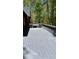 View of a spacious outdoor wooden deck with gray paint, railings, and trees in the background at 225 Austin Oaks Se Dr, Ellenwood, GA 30294
