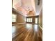 Spacious living room featuring natural light, wood floors, and a tray ceiling with a ceiling fan at 225 Austin Oaks Se Dr, Ellenwood, GA 30294