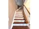 Traditional staircase with wood treads, white risers, and a white railing leading to the upper level at 225 Austin Oaks Se Dr, Ellenwood, GA 30294