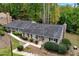 Aerial shot showcasing the home's exterior, driveway, and well-maintained landscaping in a wooded area at 2404 Northlake Ct, Atlanta, GA 30345