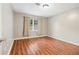 Cozy bedroom with laminate wood floors, a window, and neutral paint at 2404 Northlake Ct, Atlanta, GA 30345