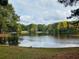 A stunning view of the tranquil lake surrounded by the colors of autumn at 2404 Northlake Ct, Atlanta, GA 30345