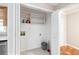Bright laundry area with storage shelves, tiled floor, and washer/dryer hookups at 2404 Northlake Ct, Atlanta, GA 30345